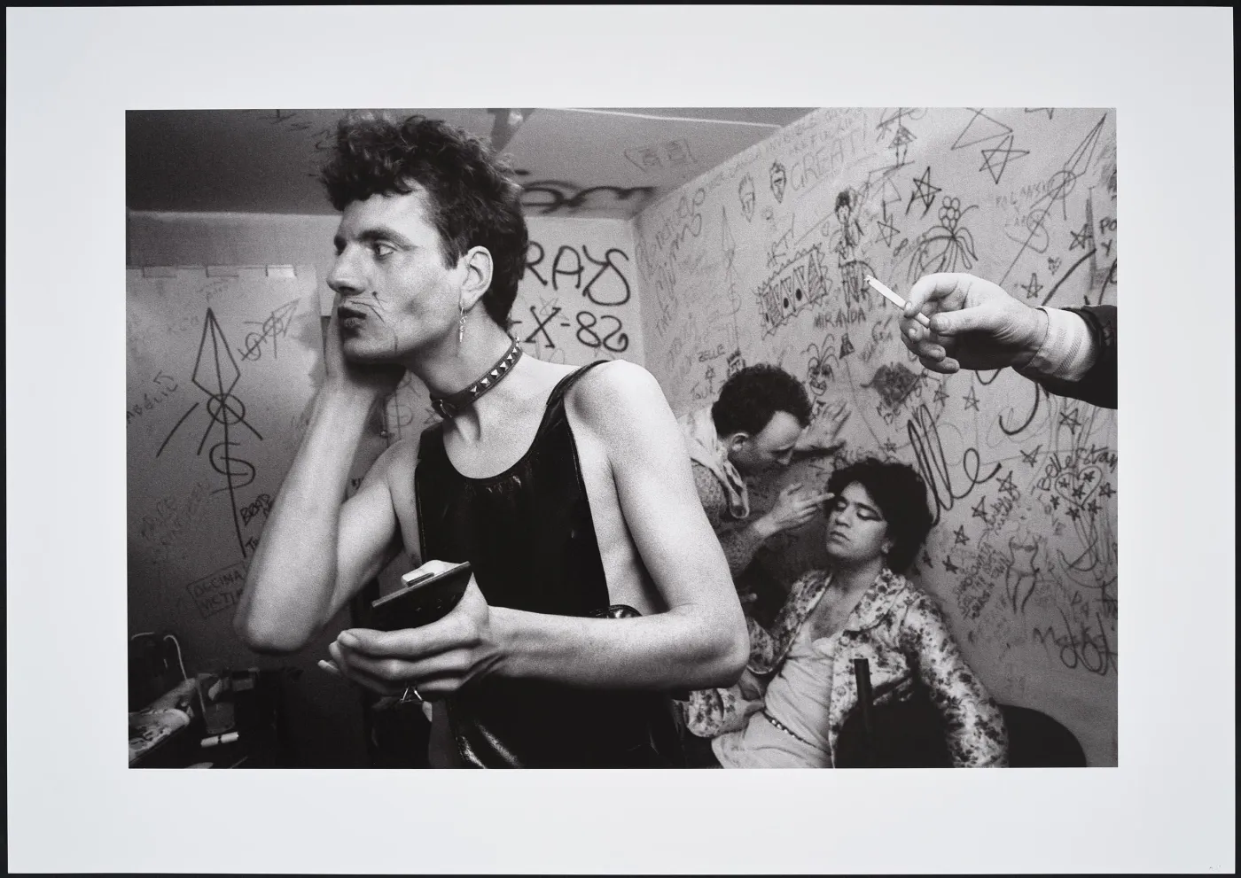 fabio mcnamara and pedro almodóvar in a dressing room covered in graffiti