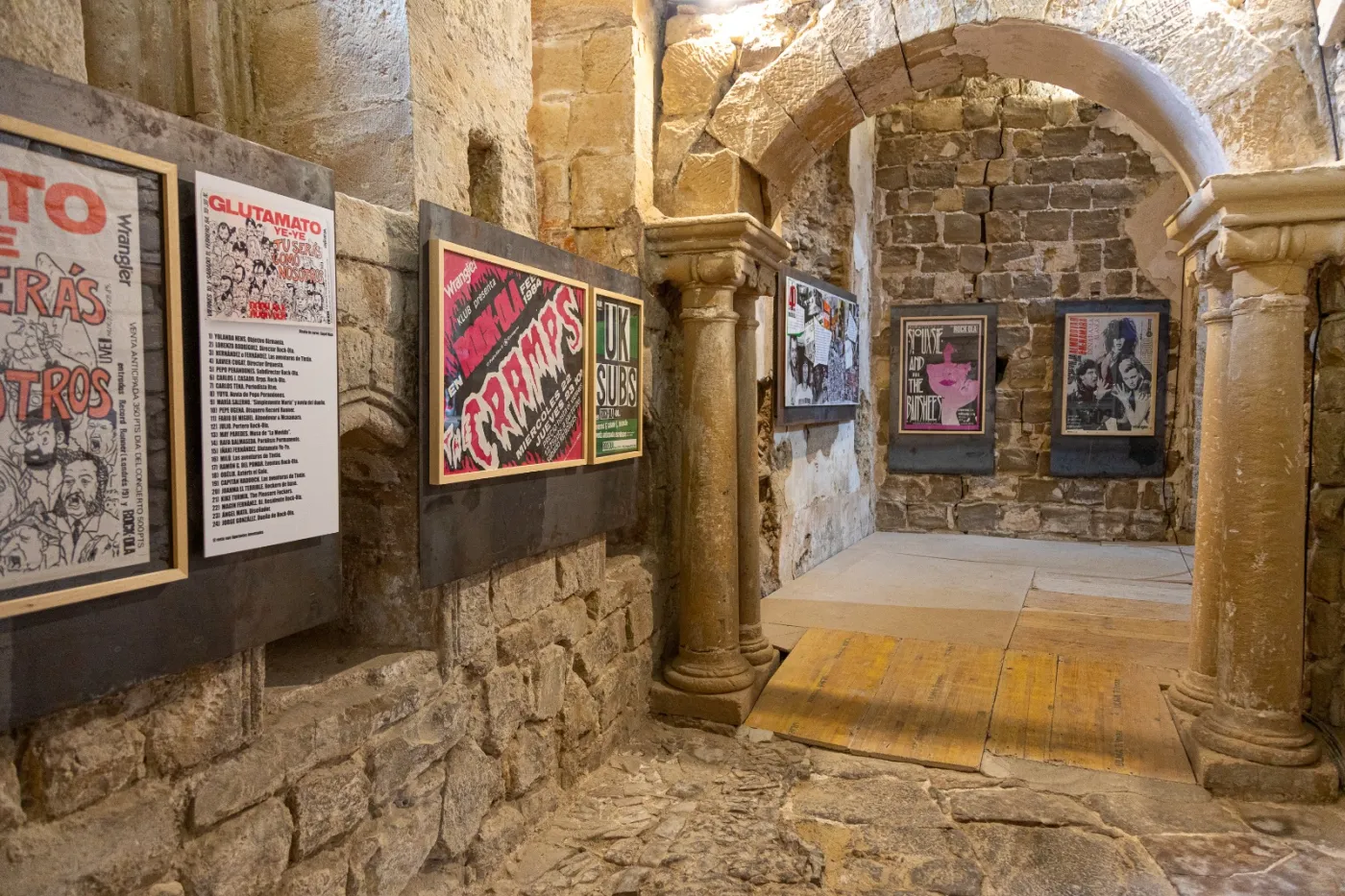 rock-ola posters hung inside a stone church