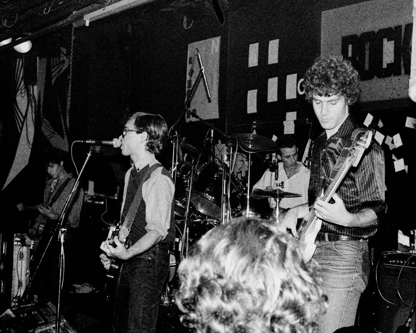 nacha pop on stage with part of the rock-ola sign behind them