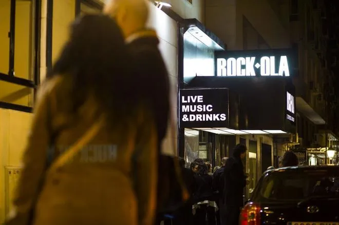 the lit rock-ola sign over the door of the new club